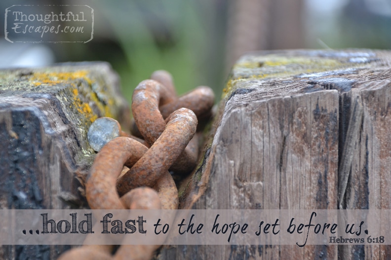 rusty chain on wooden post w verse